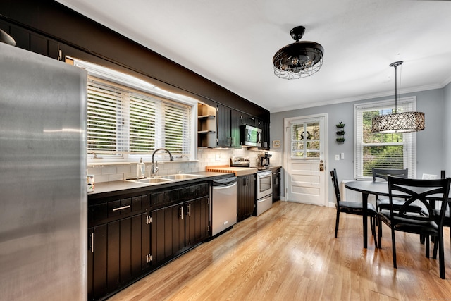 1 Stevens Rd, Middlebury, CT 06762 - kitchen featuring stainless steel appliances, a sink, light wood finished floors, crown molding, and tasteful backsplash