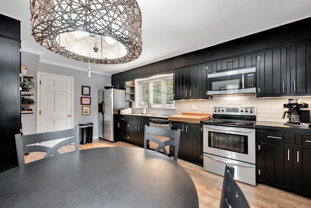 1 Stevens Rd, Middlebury, CT 06762 - kitchen with stainless steel appliances, dark cabinets, crown molding, tasteful backsplash, and open shelves