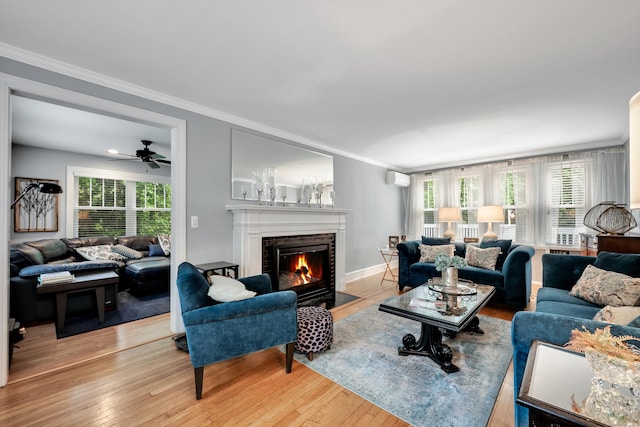 1 Stevens Rd, Middlebury, CT 06762 - living area with light wood-style flooring, ornamental molding, a fireplace, healthy amount of natural light, and a ceiling fan