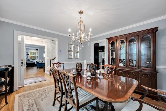1 Stevens Rd, Middlebury, CT 06762 - dining area with a chandelier, crown molding, and light wood-type flooring