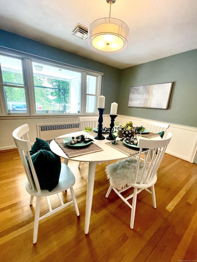 35 W Ridge Dr, West Hartford, CT 06117 - dining area with radiator, wood finished floors, wainscoting, and breakfast area