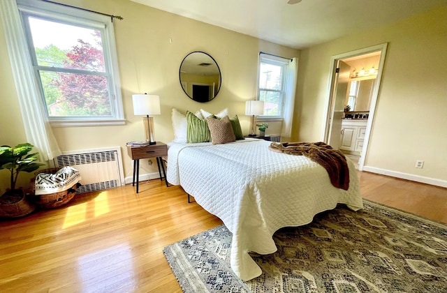 35 W Ridge Dr, West Hartford, CT 06117 - bedroom with radiator, wood finished floors, baseboards, and ensuite bath