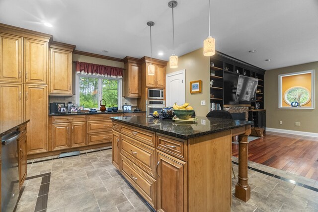 238 Park Rd, Oxford, CT 06478 - kitchen featuring appliances with stainless steel finishes, a breakfast bar area, baseboards, a kitchen island, and light stone finish flooring
