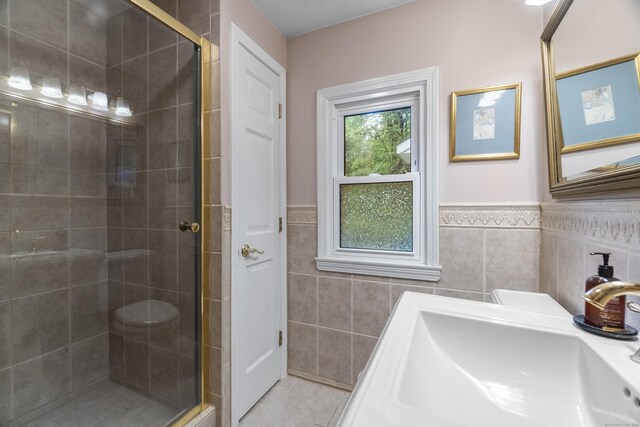 238 Park Rd, Oxford, CT 06478 - full bathroom with a shower stall, tile walls, tile patterned flooring, a sink, and a wainscoted wall