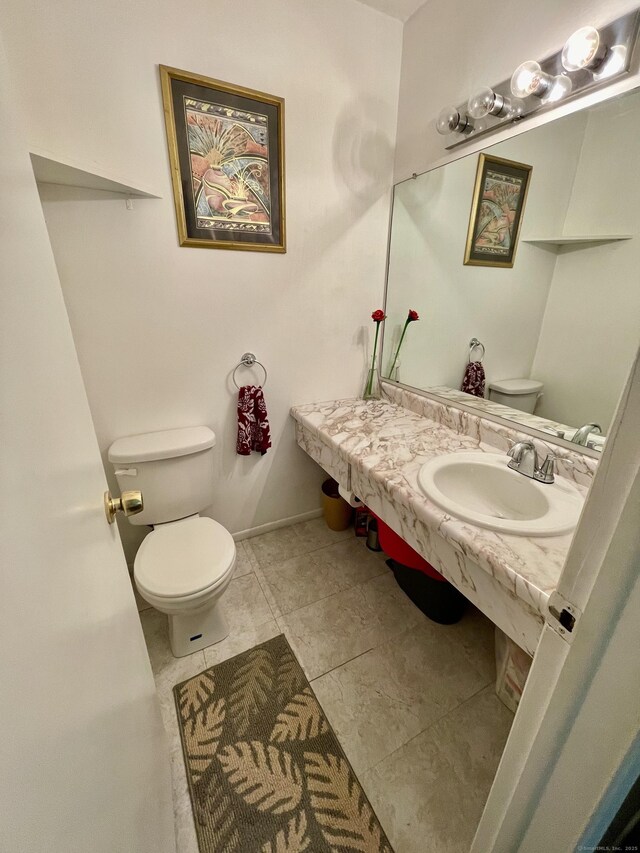 200 Woodmont Ave Apt 127, Bridgeport, CT 06606 - bathroom with toilet, a sink, and tile patterned floors