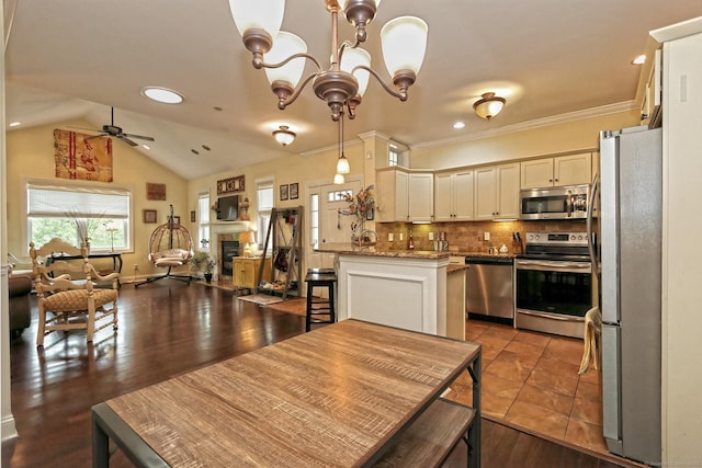 95 S Ridge Ln Unit A203, Berlin, CT 06037 - kitchen with appliances with stainless steel finishes, open floor plan, a ceiling fan, a chandelier, and decorative backsplash