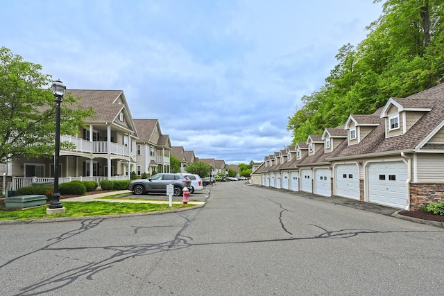 95 S Ridge Ln Unit A203, Berlin, CT 06037 - view of asphalt street featuring a residential view, community garages, and street lighting