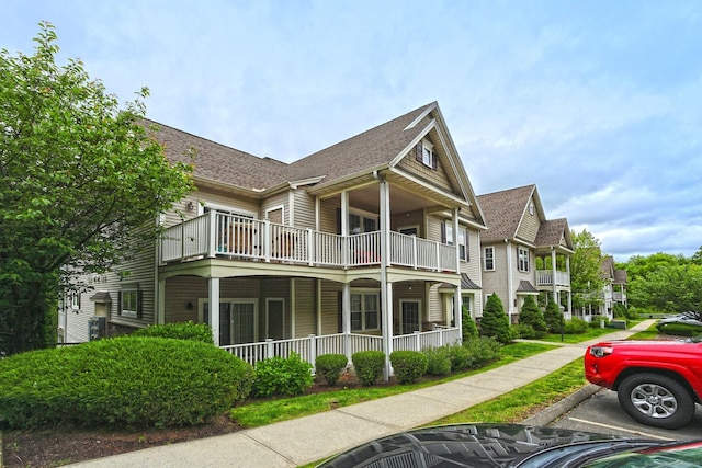 95 S Ridge Ln Unit A203, Berlin, CT 06037 - view of home's exterior featuring uncovered parking, a balcony, a porch, a shingled roof, and a residential view