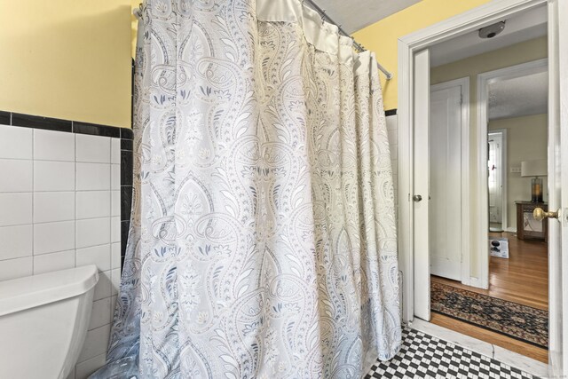 116 Maple St, Wethersfield, CT 06109 - bathroom featuring tile walls, toilet, and a shower with shower curtain