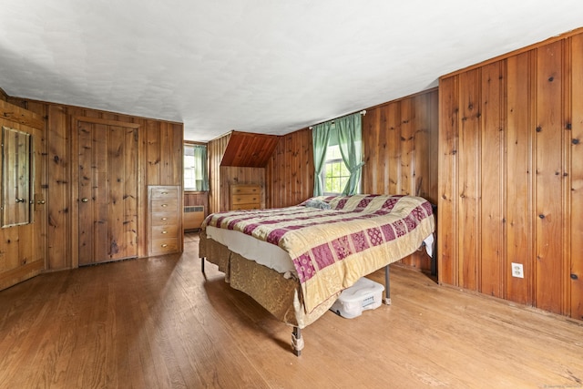 116 Maple St, Wethersfield, CT 06109 - bedroom with radiator heating unit, wood finished floors, and wood walls