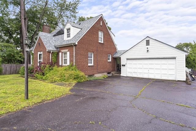 116 Maple St, Wethersfield, CT 06109 - view of side of property featuring brick siding, a chimney, an outdoor structure, and a shingled roof