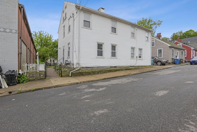 8 3rd St, Norwich, CT 06360 - view of side of home with a chimney and a gate