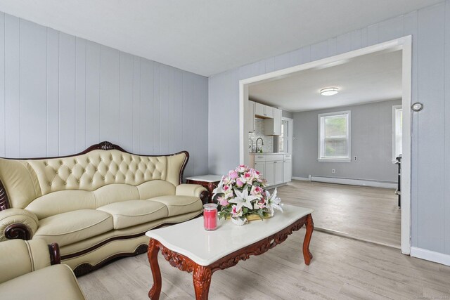 8 3rd St, Norwich, CT 06360 - living room with a baseboard radiator, light wood-style flooring, and baseboards