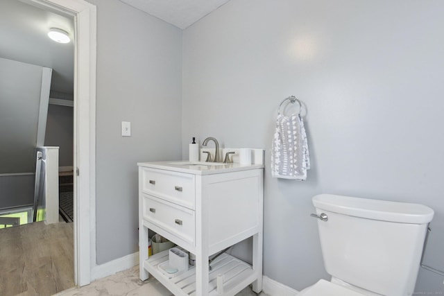8 3rd St, Norwich, CT 06360 - bathroom featuring toilet, marble look tile flooring, vanity, and baseboards