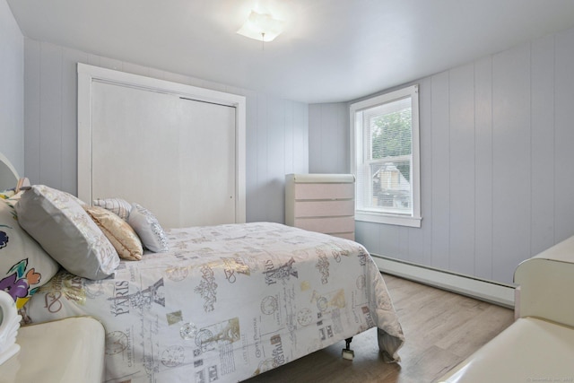 8 3rd St, Norwich, CT 06360 - bedroom featuring wood finished floors, a baseboard radiator, and a closet
