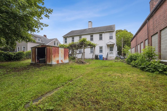 8 3rd St, Norwich, CT 06360 - rear view of house with a chimney and a lawn