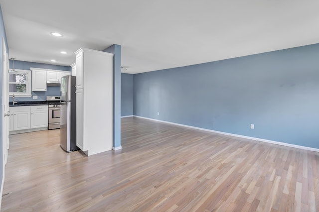 77 Shea Ave Unit 77, Milford, CT 06460 - unfurnished living room featuring baseboards, recessed lighting, and light wood-style floors