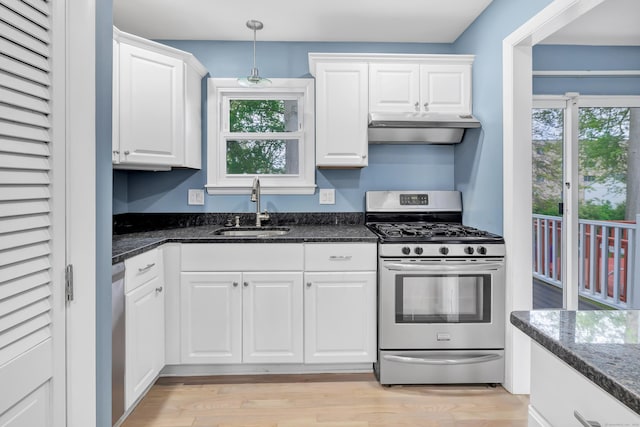 77 Shea Ave Unit 77, Milford, CT 06460 - kitchen featuring appliances with stainless steel finishes, a sink, under cabinet range hood, white cabinetry, and dark stone counters