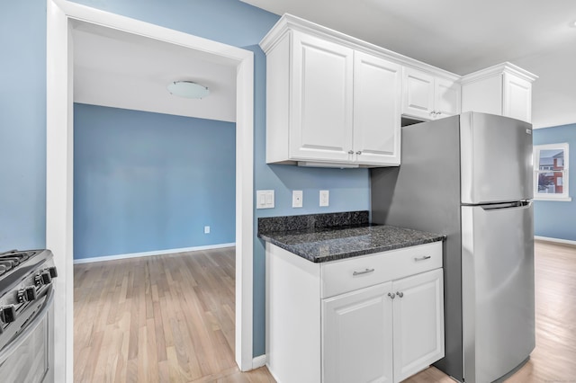 77 Shea Ave Unit 77, Milford, CT 06460 - kitchen featuring appliances with stainless steel finishes, white cabinetry, light wood-style floors, and baseboards