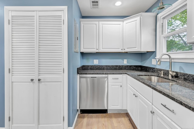 77 Shea Ave Unit 77, Milford, CT 06460 - kitchen featuring dishwasher, a sink, white cabinets, light wood-style floors, and dark stone counters