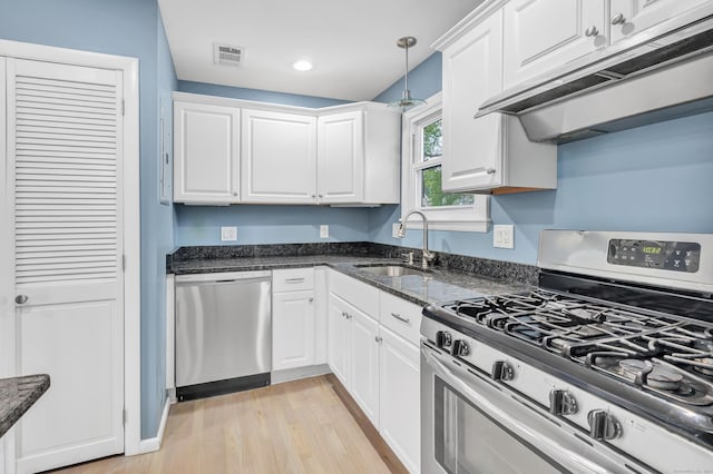 77 Shea Ave Unit 77, Milford, CT 06460 - kitchen with appliances with stainless steel finishes, range hood, a sink, white cabinets, and recessed lighting