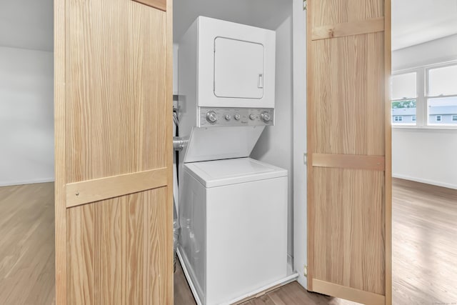 77 Shea Ave Unit 77, Milford, CT 06460 - laundry room featuring stacked washer / dryer, light wood-type flooring, and baseboards