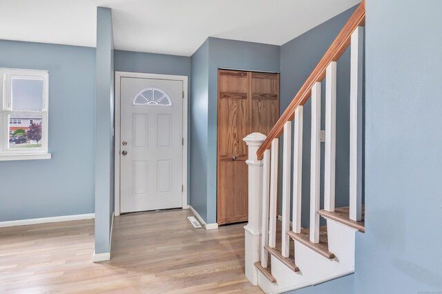77 Shea Ave Unit 77, Milford, CT 06460 - foyer entrance with stairway, light wood-style floors, baseboards, and healthy amount of natural light