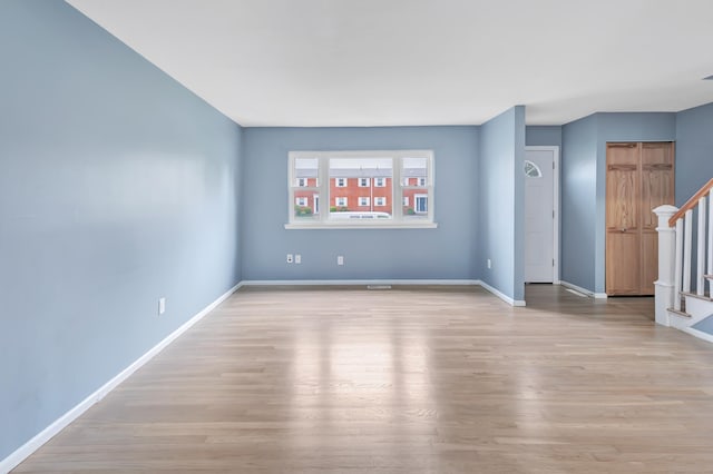 77 Shea Ave Unit 77, Milford, CT 06460 - unfurnished room featuring stairs, light wood-type flooring, and baseboards