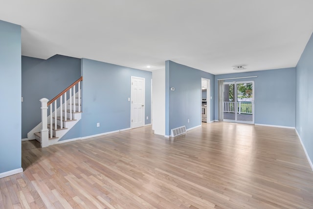 77 Shea Ave Unit 77, Milford, CT 06460 - unfurnished living room with baseboards, light wood-type flooring, and stairs