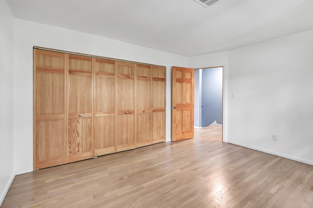 77 Shea Ave Unit 77, Milford, CT 06460 - unfurnished bedroom featuring light wood-style floors, baseboards, and a closet