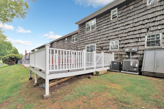 77 Shea Ave Unit 77, Milford, CT 06460 - back of house featuring central air condition unit, a deck, and a lawn