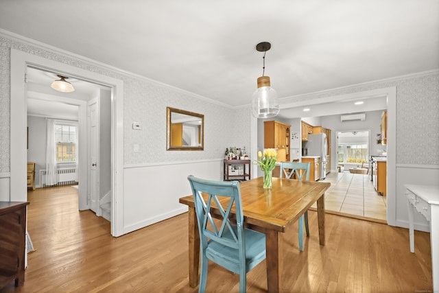 17 Chester Rd, Easton, CT 06612 - dining area with radiator, a wall mounted AC, ornamental molding, light wood finished floors, and wainscoting