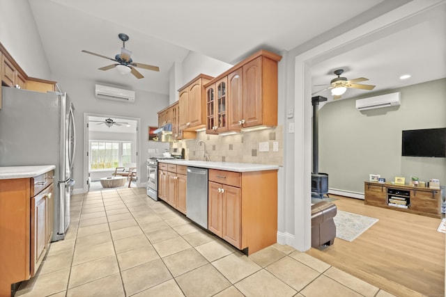 17 Chester Rd, Easton, CT 06612 - kitchen featuring appliances with stainless steel finishes, a ceiling fan, a wood stove, baseboard heating, and an AC wall unit