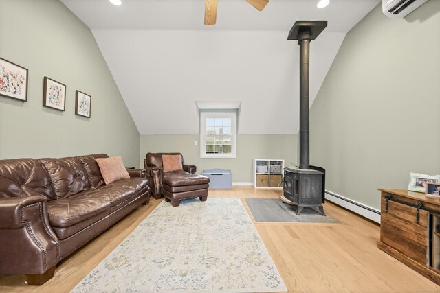 17 Chester Rd, Easton, CT 06612 - living area with baseboard heating, a wood stove, lofted ceiling, an AC wall unit, and wood finished floors