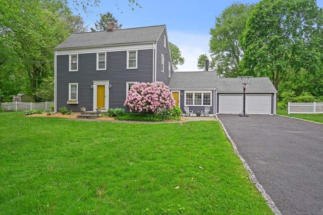 17 Chester Rd, Easton, CT 06612 - colonial-style house featuring an attached garage, driveway, a chimney, and roof with shingles