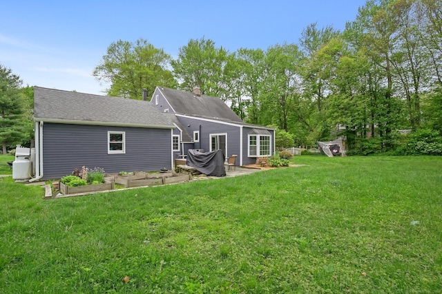 17 Chester Rd, Easton, CT 06612 - back of house featuring a vegetable garden, a lawn, a chimney, and a patio area