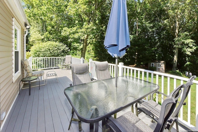 107 Colchester Commons, Colchester, CT 06415 - wooden terrace featuring outdoor dining area, a storage unit, and a yard