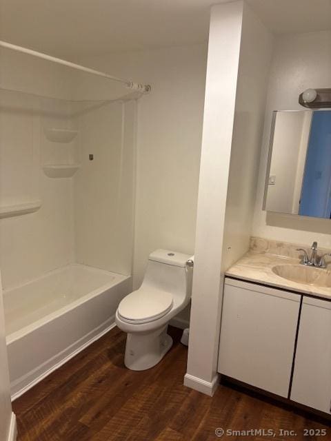 61 Clinton Ave Unit 2, Stamford, CT 06901 - bathroom featuring vanity, toilet, wood finished floors, and washtub / shower combination
