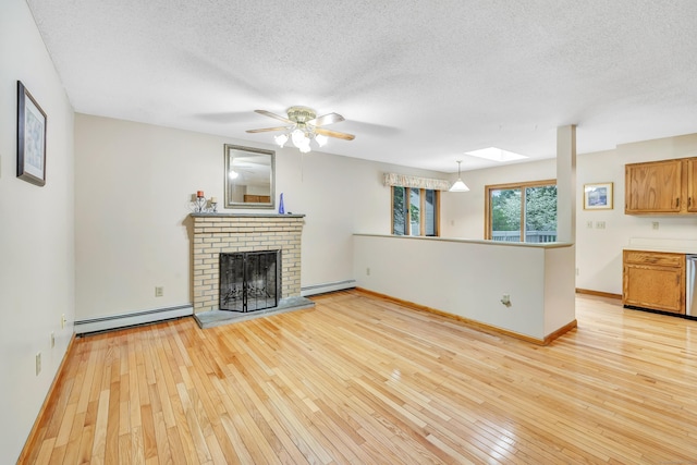 9 Cypress Ln, Trumbull, CT 06611 - unfurnished living room with baseboard heating, light wood-style flooring, a textured ceiling, a ceiling fan, and baseboards