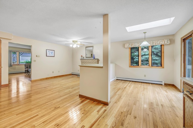 9 Cypress Ln, Trumbull, CT 06611 - unfurnished living room featuring a baseboard heating unit, a skylight, baseboard heating, and light wood-style flooring