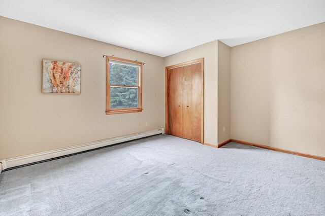9 Cypress Ln, Trumbull, CT 06611 - unfurnished bedroom featuring baseboard heating, carpet, baseboards, and a closet