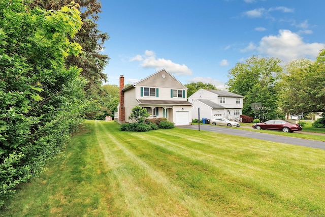 9 Cypress Ln, Trumbull, CT 06611 - traditional-style house with asphalt driveway, a chimney, a garage, and a front lawn