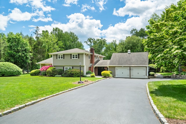 19 Huckleberry Dr S, Norwalk, CT 06850 - view of front of home featuring driveway, a garage, a front lawn, and a chimney