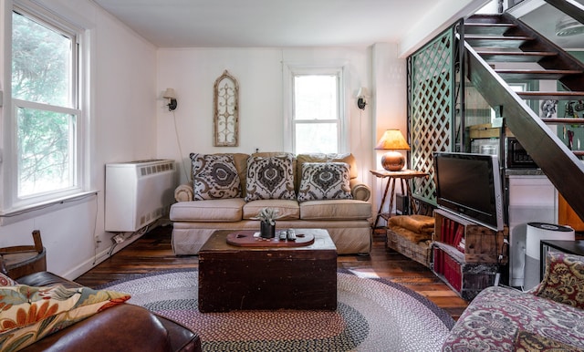 81 Milton Rd, Goshen, CT 06756 - living room featuring wood finished floors, radiator heating unit, and stairs