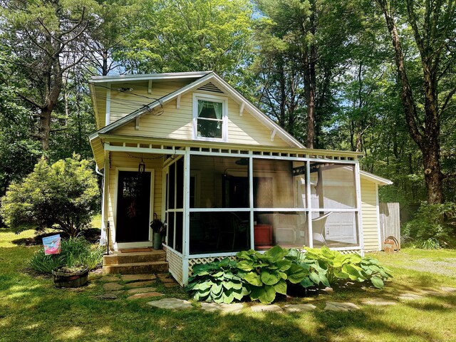 81 Milton Rd, Goshen, CT 06756 - rear view of house with a sunroom, entry steps, and a lawn