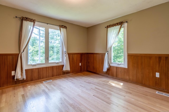 131 Spring Brook Dr, Middletown, CT 06457 - spare room with a wainscoted wall, plenty of natural light, wood finished floors, and wooden walls
