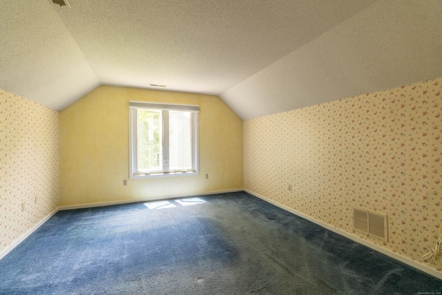 131 Spring Brook Dr, Middletown, CT 06457 - additional living space featuring wallpapered walls, vaulted ceiling, carpet, a textured ceiling, and baseboards