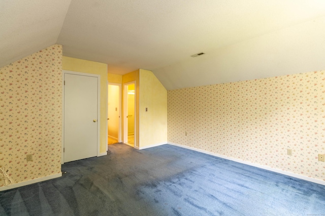 131 Spring Brook Dr, Middletown, CT 06457 - bonus room with lofted ceiling, wallpapered walls, dark colored carpet, and baseboards
