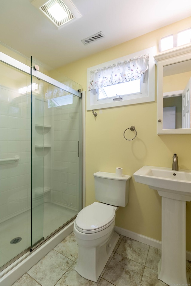 131 Spring Brook Dr, Middletown, CT 06457 - bathroom featuring toilet, a shower stall, tile patterned flooring, a sink, and baseboards