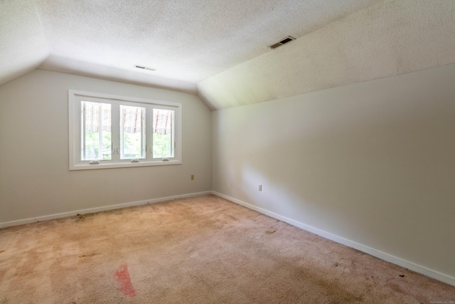 131 Spring Brook Dr, Middletown, CT 06457 - bonus room featuring lofted ceiling, light colored carpet, a textured ceiling, and baseboards